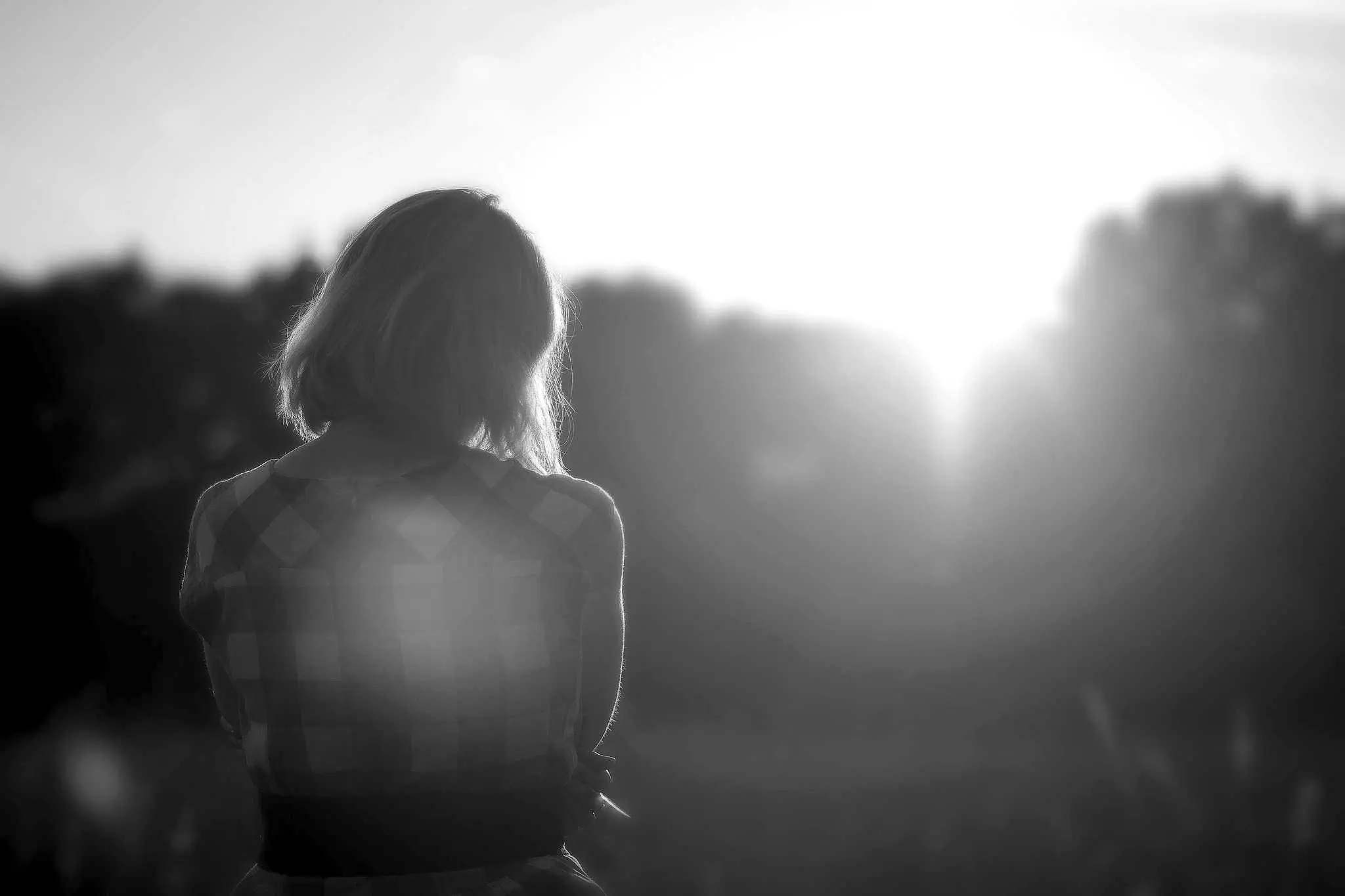 A woman in profile against bright backlight