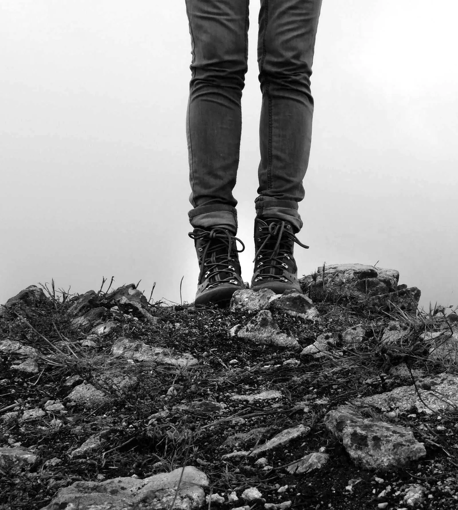 Legs and boots on a rocky ledge