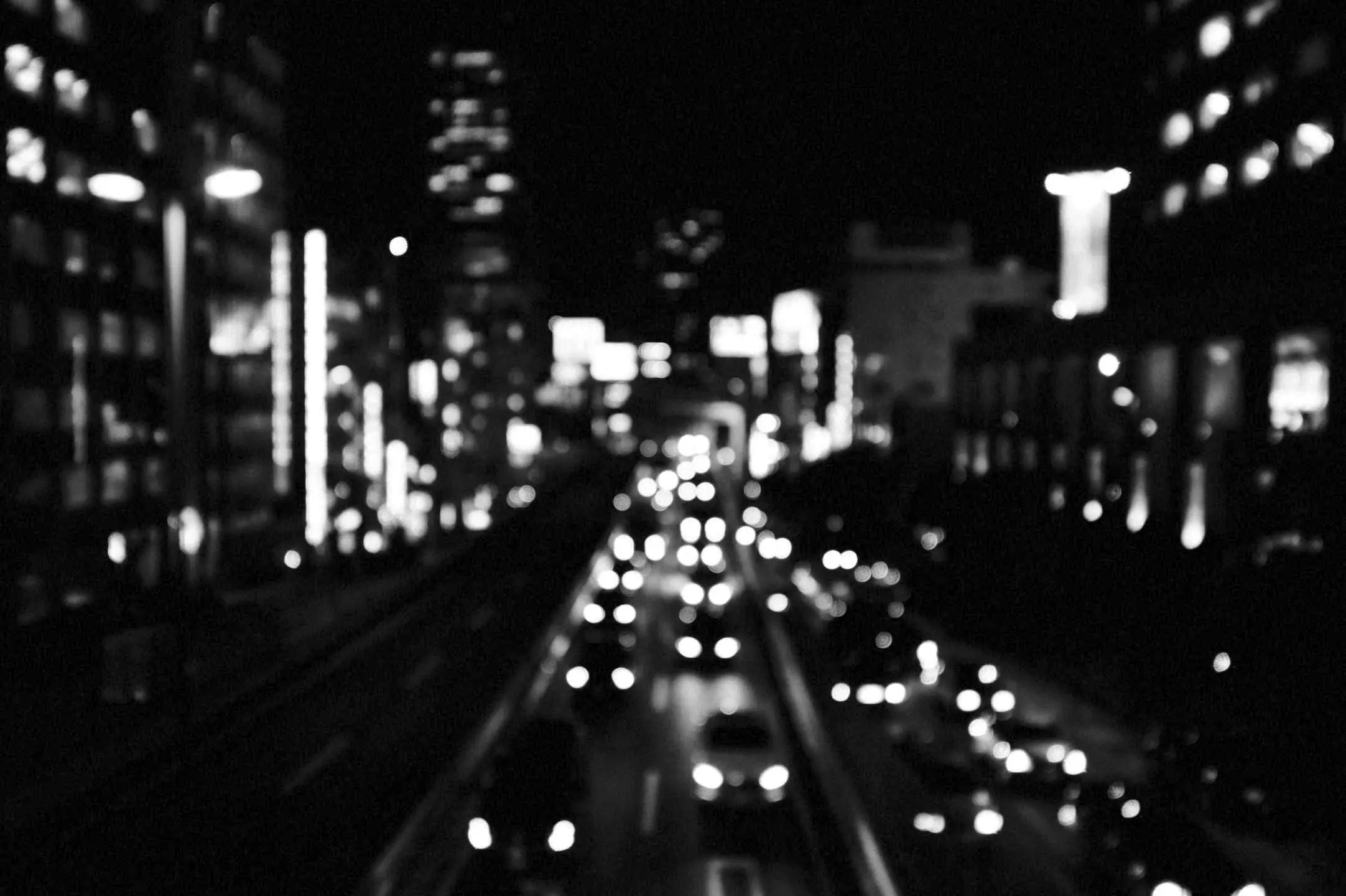 Traffic lights smeared along a night street