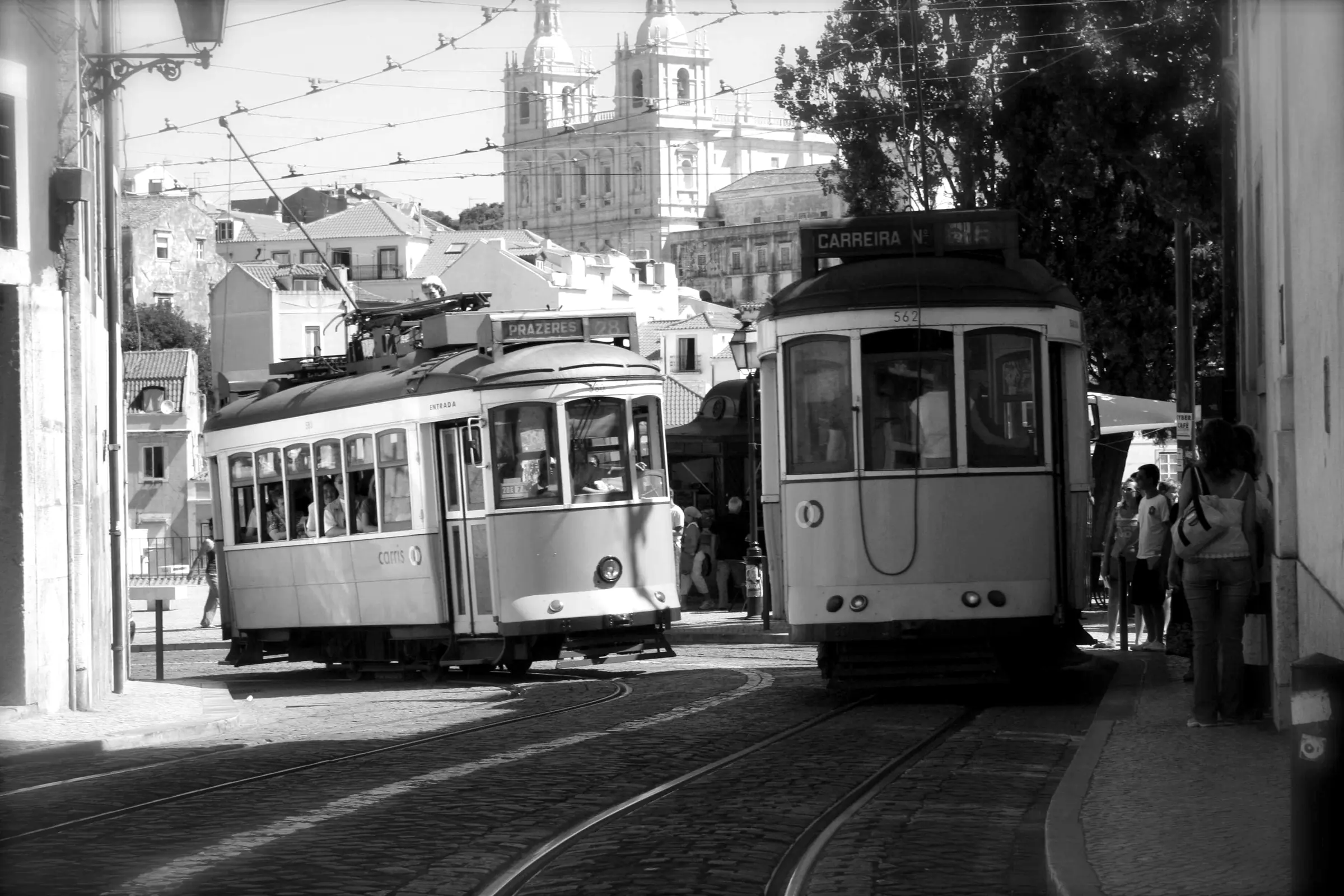 Two trams passing on a city street