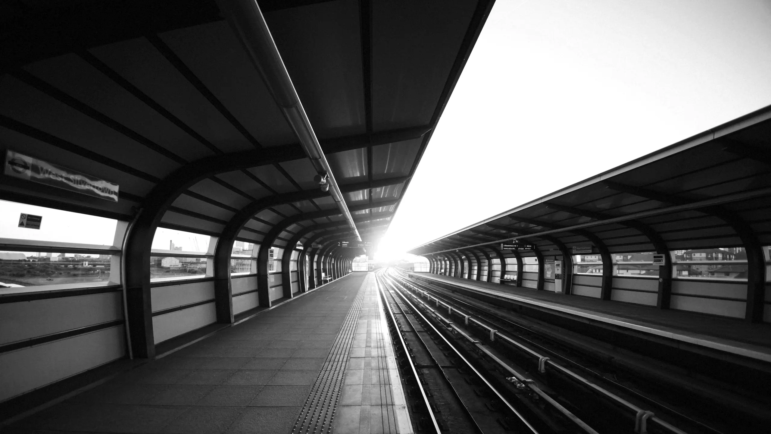 Sunlight flaring along a covered station platform