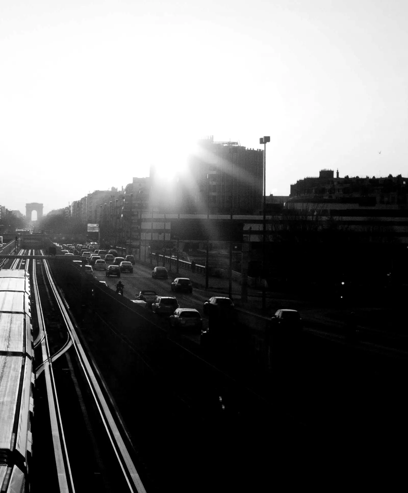 A train running down the middle of a wide avenue